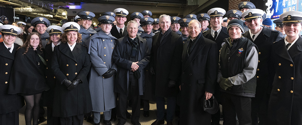 Cadets from the U.S. Military Academy and midshipmen from the U.S. Naval Academy gather with Archbishop Timothy Broglio of the Archdiocese for the Military Services, USA; Supreme Knight Patrick Kelly; and Supreme Chaplain Archbishop William Lori of Baltimore during halftime at the 126th Army-Navy football game in Baltimore on Dec. 13. (Photo by Paul Haring)