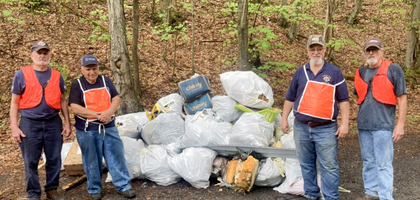 Knights from Sacred Heart of Mary Council 7622 in Jermyn, Pa., stand beside more than 40 large bags of litter collected during a recent road cleanup. 