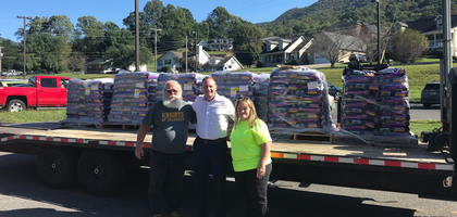 Bill McDonald (left), disaster response coordinator for the Indiana State Council, and his wife, Toni, stand with Nathanael Hughes, manager of a community donation center in Hampton, Tenn., after delivering $15,000 worth of pet food for households affected by Hurricane Helene.