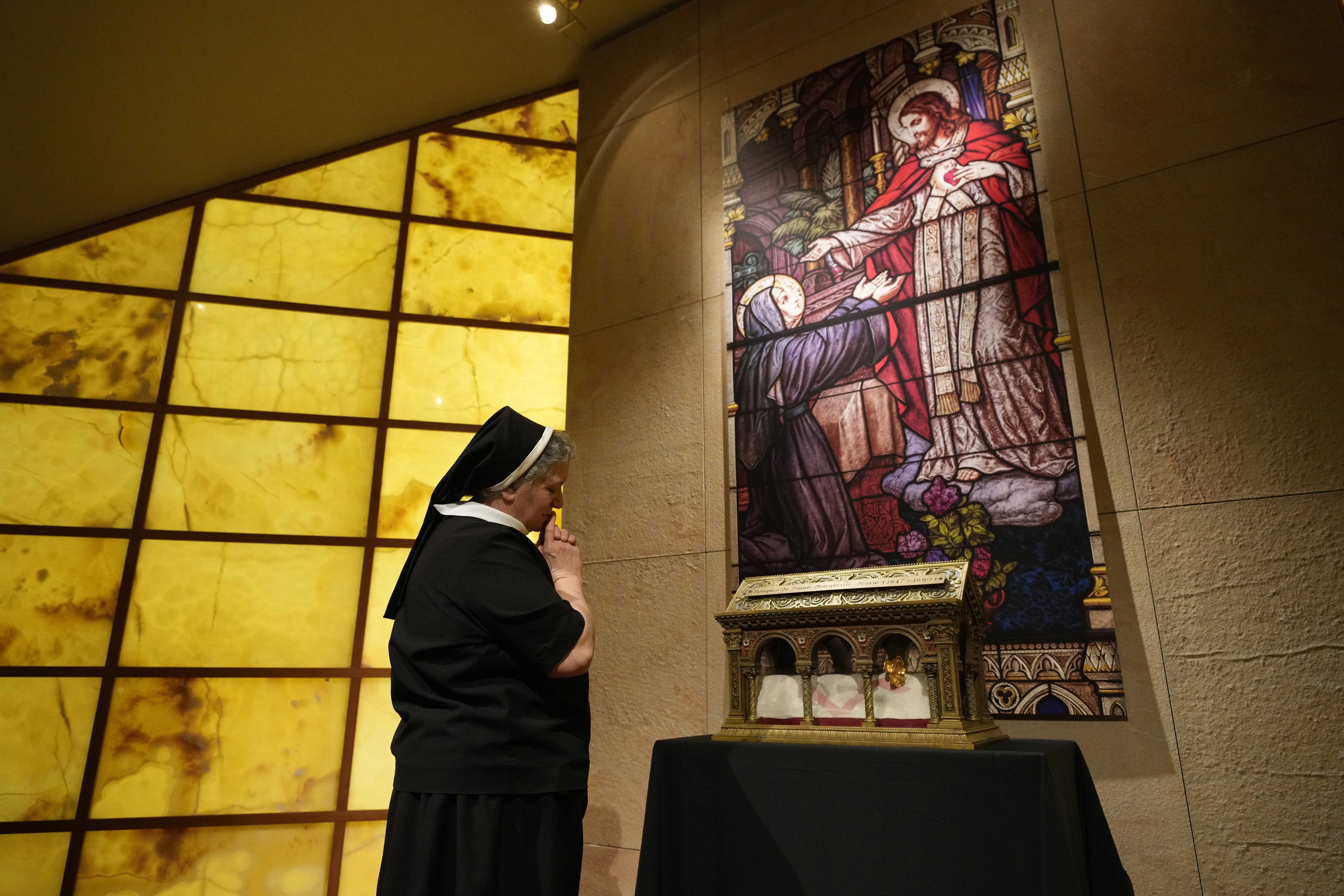 Sister Doretta D&rsquo;Albero of the Apostles of the Sacred Heart of Jesus venerates the major relics of St. Margaret Mary Alacoque.