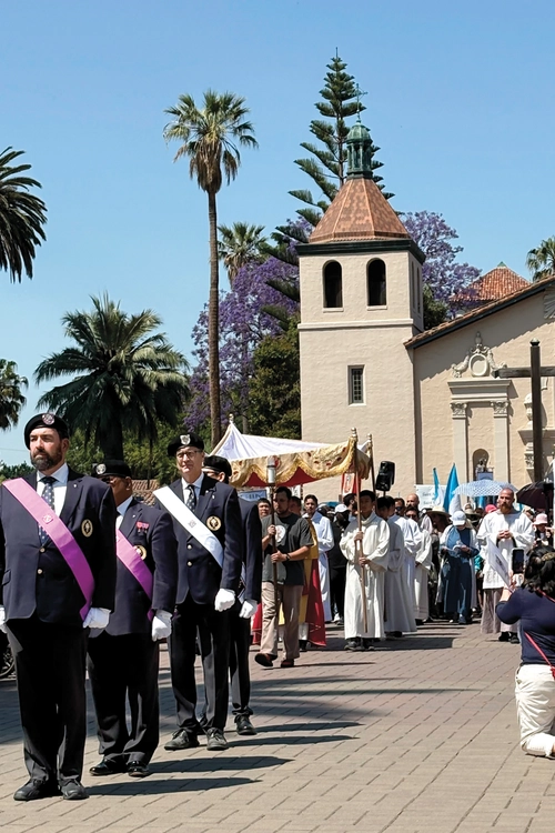 A Fourth Degree honor guard escorts the Camino de California Eucharistic Pilgrimage as it exits Mission Santa Clara de As&iacute;s on June 8. The Camino&rsquo;s itinerary included stops at all 21 of California&rsquo;s historic missions. (Photo by Greg Wood)