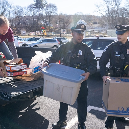 Leo Thibeault, a member of Woonsocket (R.I.) Council 113, helps police officers unload toy donations during the joint Christmas toy drive hosted by the council and the Woonsocket Police Department on Nov. 29.