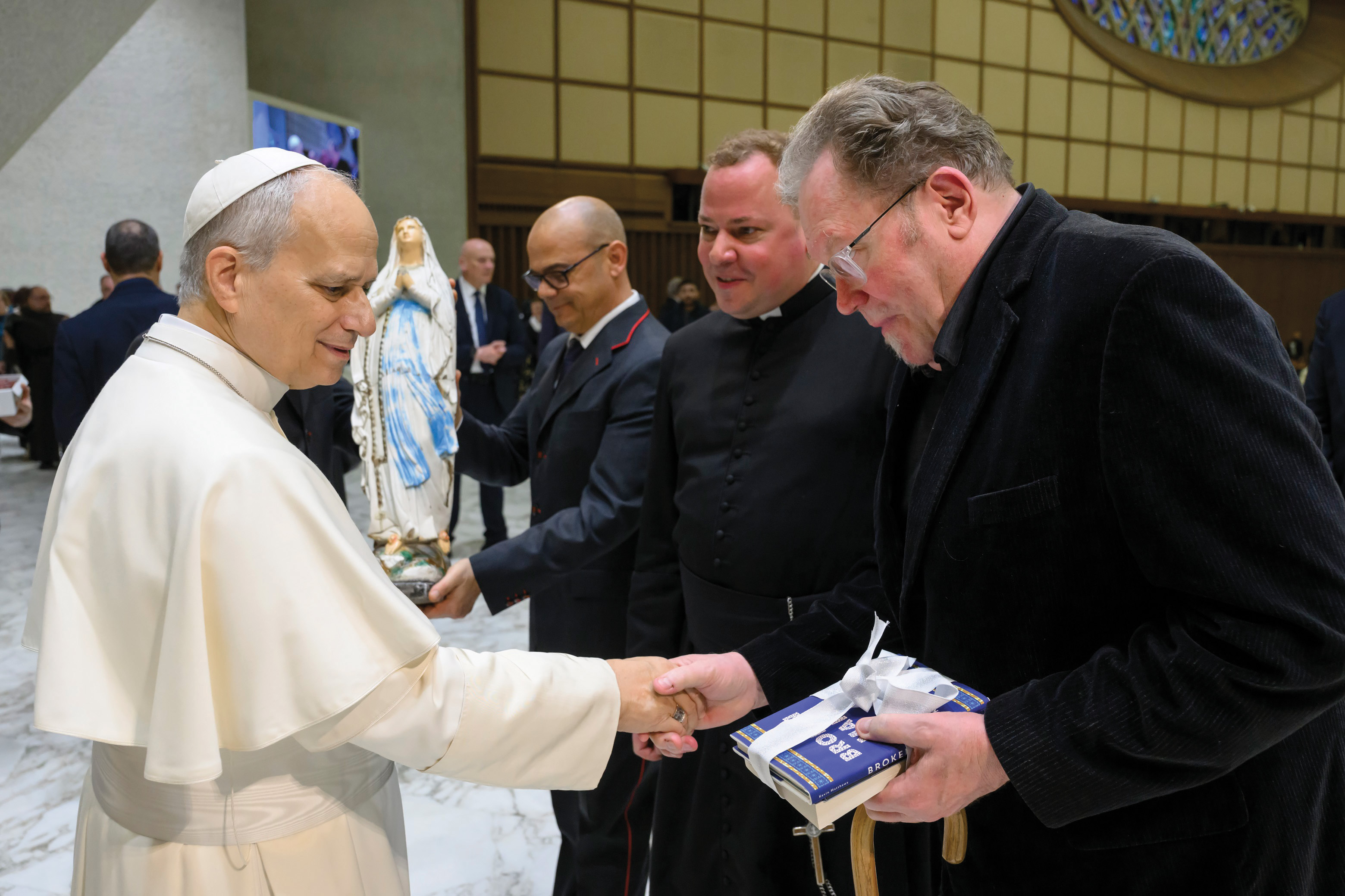 Pope Leo XIV greets Kevin Matthews (right), accompanied by Father Joshua Caswell of the Canons Regular of St. John Cantius.