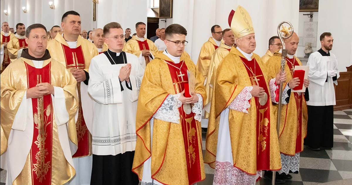 Father Konrad Szymański (center) prays during his ordination Mass, celebrated by Bishop Stanislav Shyrokoradiuk on May 27, 2023, in the Cathedral of the Assumption of the Blessed Virgin Mary in Odesa, Ukraine. (Courtesy of the Roman Catholic Church in Ukraine)