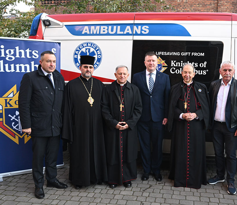 Archbishop William E. Lori visited a cemetery in warn-torn Ukraine with the Knights of Columbus and is pictured with other priests and Knights.