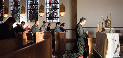 Priest and families attending a mass service in support of the Catholic Church