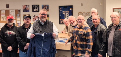 Members of Cardinal Newman Council 5266 in Stillwater, Okla., present coats purchased through the Knights of Columbus Coats for Kids program to Principal Walter Howell (holding coat) of Stillwater High School. The council raised $3,300 to purchase more than 160 coats for Stillwater Public Schools’ Pioneer Pantry.
