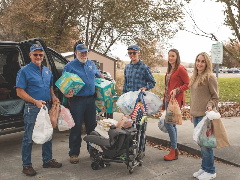 Knights and staff from the Legacy Pregnancy Center unload a truckload of diapers and other baby supplies.