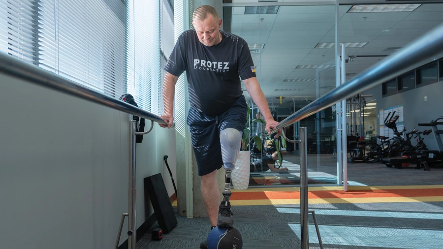 Viktor Openko exercises with his new prosthetic leg at the Protez Foundation’s rehabilitation center in Oakdale, Minn.