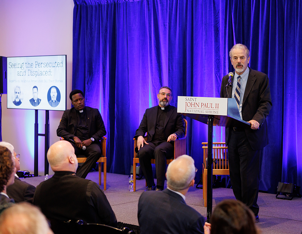 Stephen Rasche, an expert on religious persecution and violence, speaks at the opening of a photo exhibit on Christian persecution at the Saint John Paul II National Shrine in Washington, D.C., Dec. 2. (Photo by Avi Gerver)