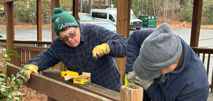 Grand Knight Nick Weir (left) and Past Grand Knight Soulith Saysanavong of St. Peter Chanel Council 13217 in Roswell, Ga., repair a gate at In Community's Unlimited Possibilities Center in Roswell.