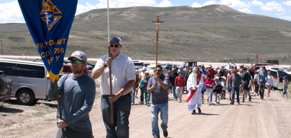 Knights from Father Pierre De Smet Council 9756 in Pinedale, Wyo., carry their council banner, a U.S. flag and a crucifix as they lead 150 parishioners of Our Lady of Peace Church in a 2.5-mile pilgrimage to the site where Jesuit missionary Father Pierre De Smet celebrated the first Mass in Wyoming in 1840. The pilgrims prayed a rosary at the original stone altar, which is now enclosed by a small chapel.