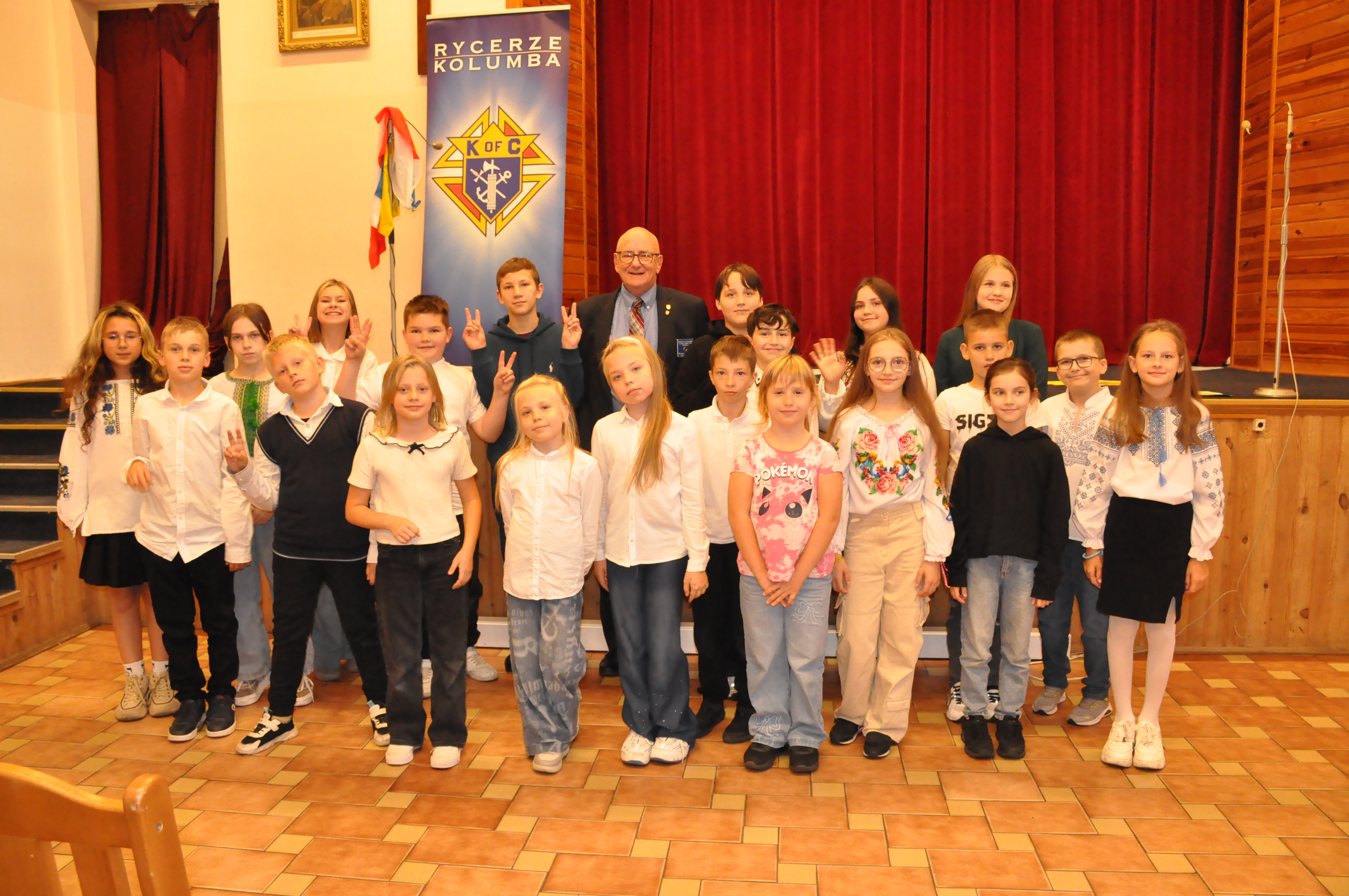 Past Grand Knight Robert Szyman of Father Perez Council 1444 in Chicago stands with Ukrainian refugee children at the Knights of Columbus Mercy Center at St. Klemens Hofbauer Parish in Warsaw, Poland, in September 2025.