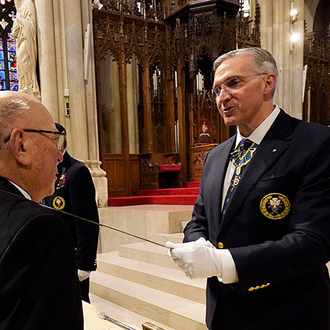 Supreme Knight Patrick Kelly dubs a new Fourth Degree “Sir Knight” during the knighting ceremony concluding the Exemplification of Patriotism Feb. 22. (Photo by Gregory Shemitz)
