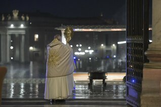 Pope Francis gives a blessing while holding the monstrance. 