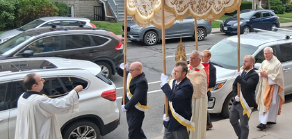 Members of Frontenac Council 728 in Kingston, Ontario, carry the canopy over Father Shawn Hughes, rector of St. Mary’s Cathedral and council chaplain, as he carries the monstrance for a Eucharistic procession on Corpus Christi Sunday, June 22, around the grounds of St. Mary Cathedral. About 200 people processed a quarter-mile around the cathedral before returning for Eucharistic adoration.
