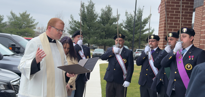 Members of Father J.A. Nieuwland Assembly 242 in South Bend, Ind., stand at attention as Father Jason Freiburger, pastor of St. Monica Catholic Church and chaplain of St. Monica Council 17947 in Mishawaka, blesses a new Safe Haven Baby Box installed at Mishawaka Fire Station 2. 