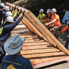 Santiago Catholic Trade School instructor Jeff Rice (foreground) oversees students constructing a confessional.