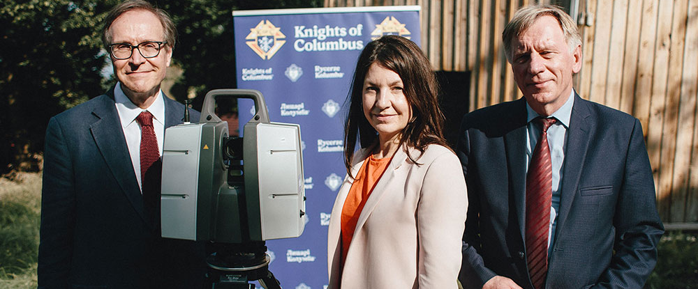 3 people standing with meauring equipment