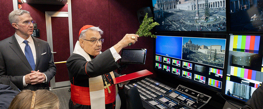 Cardinal Marcello Semeraro, prefect of the Vatican’s Dicastery for the Causes of Saints, is accompanied by Supreme Knight Patrick Kelly as he blesses a new mobile broadcasting unit outside St. Peter’s Basilica in Rome on Dec. 21. 