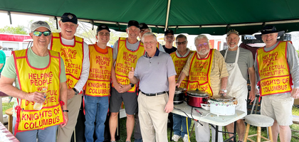 Sen. Lindsey Graham (center) joins Knights from St. Gerard Majella Council 6884 in Seneca, S.C., inside the council’s food tent at the 48th annual Pendleton Spring Jubilee arts festival.