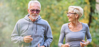 An elderly couple jogging.