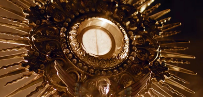 Angled shot of a monstrance with smoke all around.