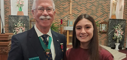 Jack Gustafson, district marshal for the Fourth Degree in the Diocese of Shreveport, La., and member of Msgr. John C. Marsh Assembly 329 in Monroe, presents eighth grader Jasmine Juarez with a certificate recognizing her as winner of a patriotic essay contest organized by the Fourth Degree District of Louisiana. 