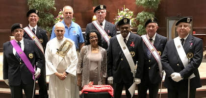 Members of Rev. James F. O’Reilly Assembly 2507 in Hoover, Ala., joined by Alabama State Deputy William Mores (blue shirt) and others, gather around a Knights of Columbus Silver Rose after a bilingual pro-life prayer service at Prince of Peace Church. About 100 parishioners attended the service, which was organized by Assembly 2507 and Prince of Peace Council 11537.