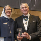 Supreme Knight Patrick E. Kelly accepts the John Cardinal O’Connor Award on behalf of the Knights of Columbus from Mother Mary Concepta, superior general of the Sisters of Life.