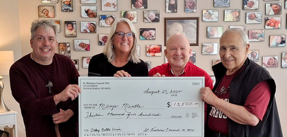 Members of St. Nicholas Council 7011 in Sterling Heights, Mich., present a $13,500 check — funds from the council’s annual baby bottle campaign — to Jessica Gaderick, office manager at Mary’s Mantle, a Catholic home for expectant mothers. Council 7011 has organized the bottle drive at Ss. Cyril and Methodius Parish for eight years, raising more than $85,000. Thanks to these contributions, the Supreme Council has matched nearly $15,000 through the Ultrasound Initiative and an additional $800 through ASAP. 