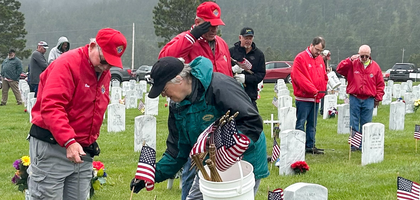 Knights from several councils near Rapid City, S.D., place flags on veterans’ graves at Black Hills National Cemetery ahead of Memorial Day. St. Therese Council 8025 has coordinated the event for more than five years.