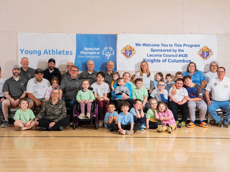 Knights and other volunteers gather with parents and participants of the Special Olympics Young Athletes program in St. Andr&eacute; Bessette Parish Hall