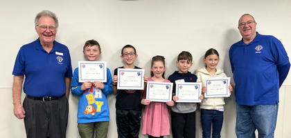 Grand Knight Joel Naber (right) and Don Breuker of St. Joseph Council 7284 in Milford, Iowa, stand with winners of the council’s annual spelling bee. Students from advanced to  the regional bee organized by the Iowa State Council.