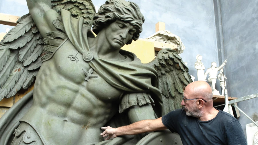 Sculptor Sergey Eylanbekov works on a statue of St. Michael the Archangel at his studio in Pietrasanta, Italy.