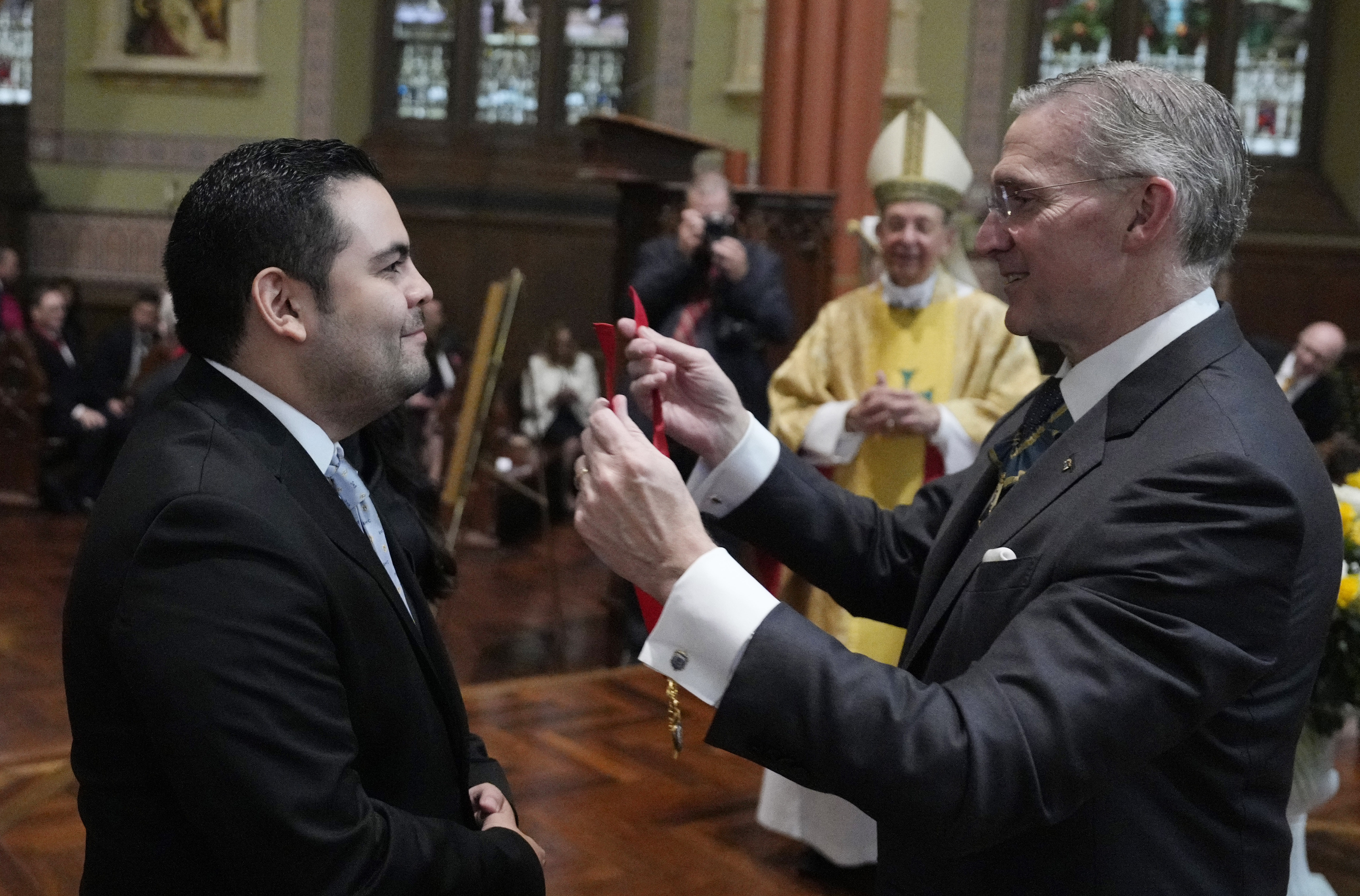 Supreme Knight Patrick Kelly confers the medal of office on Rene Sansores Medrano Jr., the new state deputy of Mexico South.