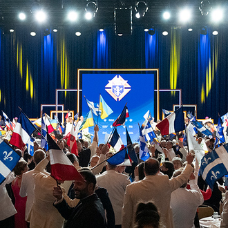 Knights of Columbus and guests wave the flags of the Order’s jurisdictions at the opening of the annual States Dinner at the 142nd Supreme Convention in Québec Aug. 6.