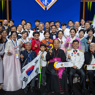 Delegates from the Republic of Korea take a photo together after the States Dinner on Aug. 6, making a popular Korean gesture, the finger heart.