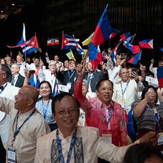 Delegates from the Philippines wave their national flag during the States Dinner of the 142nd Supreme Convention in Québec Aug. 6.