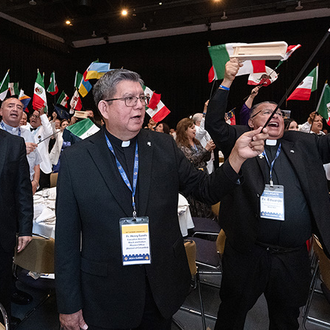 Father Henry Sands, executive director of the Black and Indian Mission Office and a longtime Knight, joins the delegates from Mexico at the States Dinner of the 142nd Supreme Convention in Québec Aug.