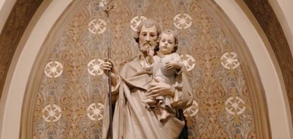 Statue of Joseph holding infant Jesus.