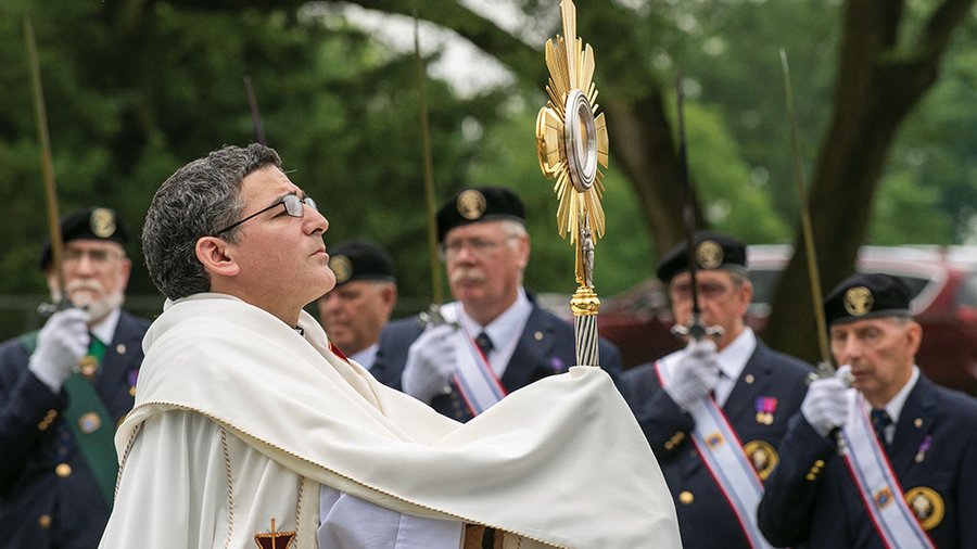 Father Andrés Ayala raises the Eucharist in benediction during National Eucharistic Pilgrimage events at the National Shrine of St. Elizabeth Ann Seton in Emmitsburg, Md., June 6.