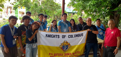 Members of Sta. Quiteria Council 8751 in Caloocan City, Luzon North, and local youth display the council’s banner during a summer camp organized by St. Francis of Assisi and Sta. Quiteria Parish. 