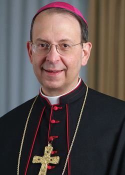 Archbishop William E. Lori, S.T.D. Supreme Chaplain smiles for a portrait.