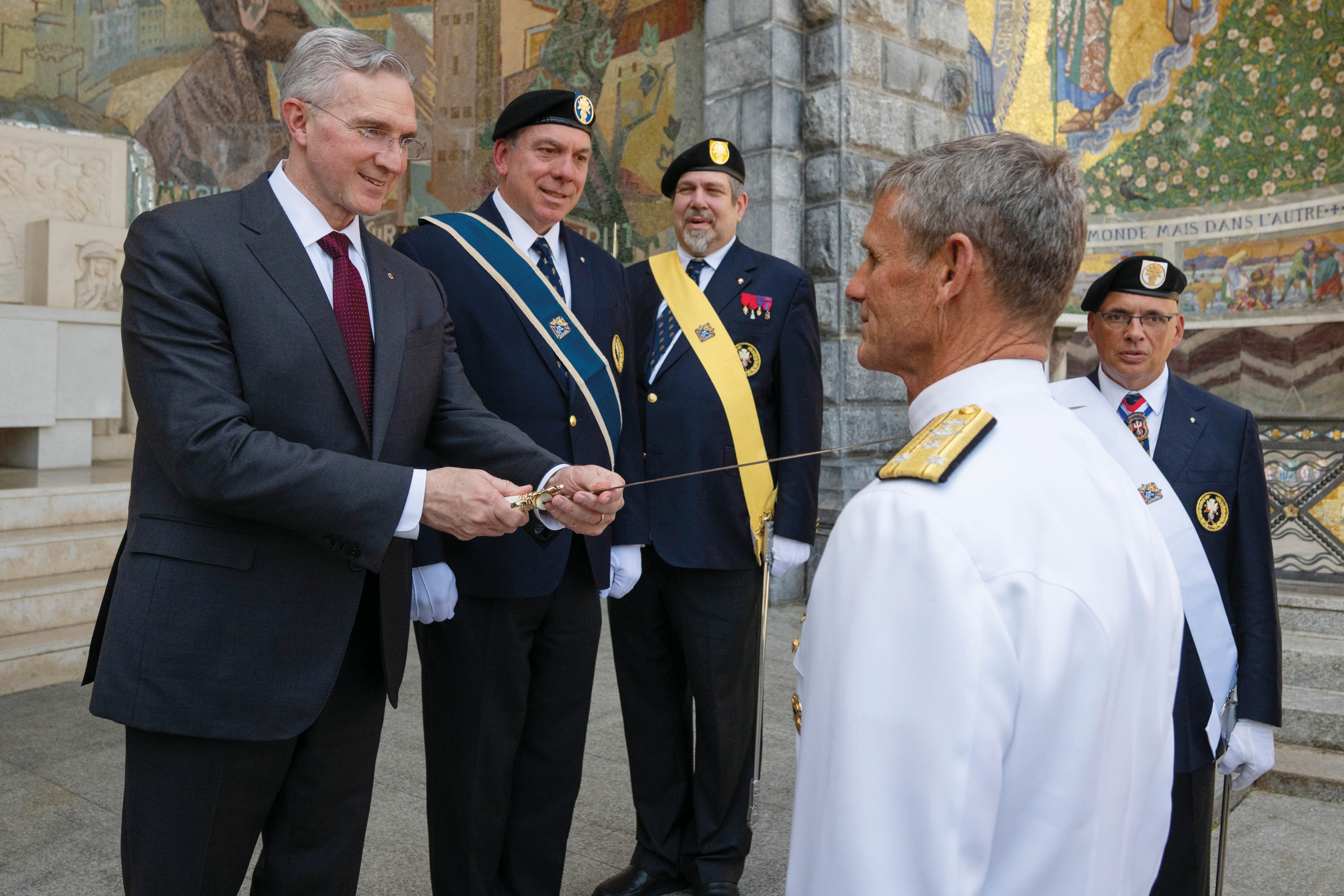 Supreme Knight Patrick Kelly knights retired Vice Adm. Andrew L. Lewis during an Exemplification of Patriotism outside the Basilica of Our Lady of the Rosary.