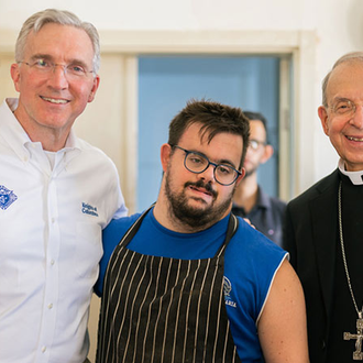 Supreme Knight Patrick Kelly and Supreme Chaplain Archbishop Lori are pictured with a worker at Piccirillo Handicraft Center, where artisans with special needs craft products from Holy Land olive trees, in Bethlehem on Sept. 4. (Photo by George Jaraiseh)