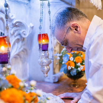 Supreme Secretary John Marrella kneels before the altar of the Grotto of the Annunciation in Nazareth — the spot where the Angel Gabriel is believed to have appeared to the Virgin Mary — on Sept. 5. (Photo by George Jaraiseh)