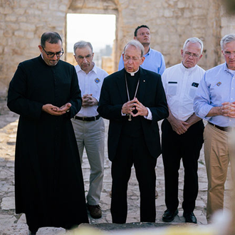 Supreme Chaplain Archbishop William Lori leads the delegation in prayer at St. George Greek Orthodox Church in the village of Taybeh in the West Bank. The church was burned in a fire set by Israeli settlers in July. (Photo by Joseph Saadeh)