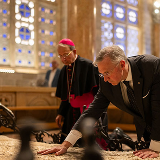 Supreme Knight Patrick Kelly and Supreme Chaplain Archbishop William Lori venerate the bedrock where Jesus is believed to have prayed before his arrest in the Garden of Gethsemani at the Church of All Nations in Jerusalem on Sept. 3. (Photo by George Jaraiseh)