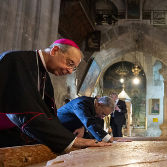 Supreme Chaplain Archbishop William Lori and Supreme Secretary John Marrella venerate the Stone of Anointing, where Jesus’ body is believed to have been anointed for burial by Joseph of Arimathea, at the Church of the Holy Sepulchre in Jerusalem on Sept. 3. (Photo by George Jaraiseh)